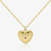 Gold paperclip chain necklace with embossed heart pendant and red gemstone center