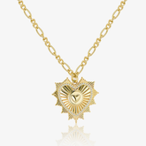 Gold Figaro chain necklace with radiant heart pendant and pavé sparkle detail