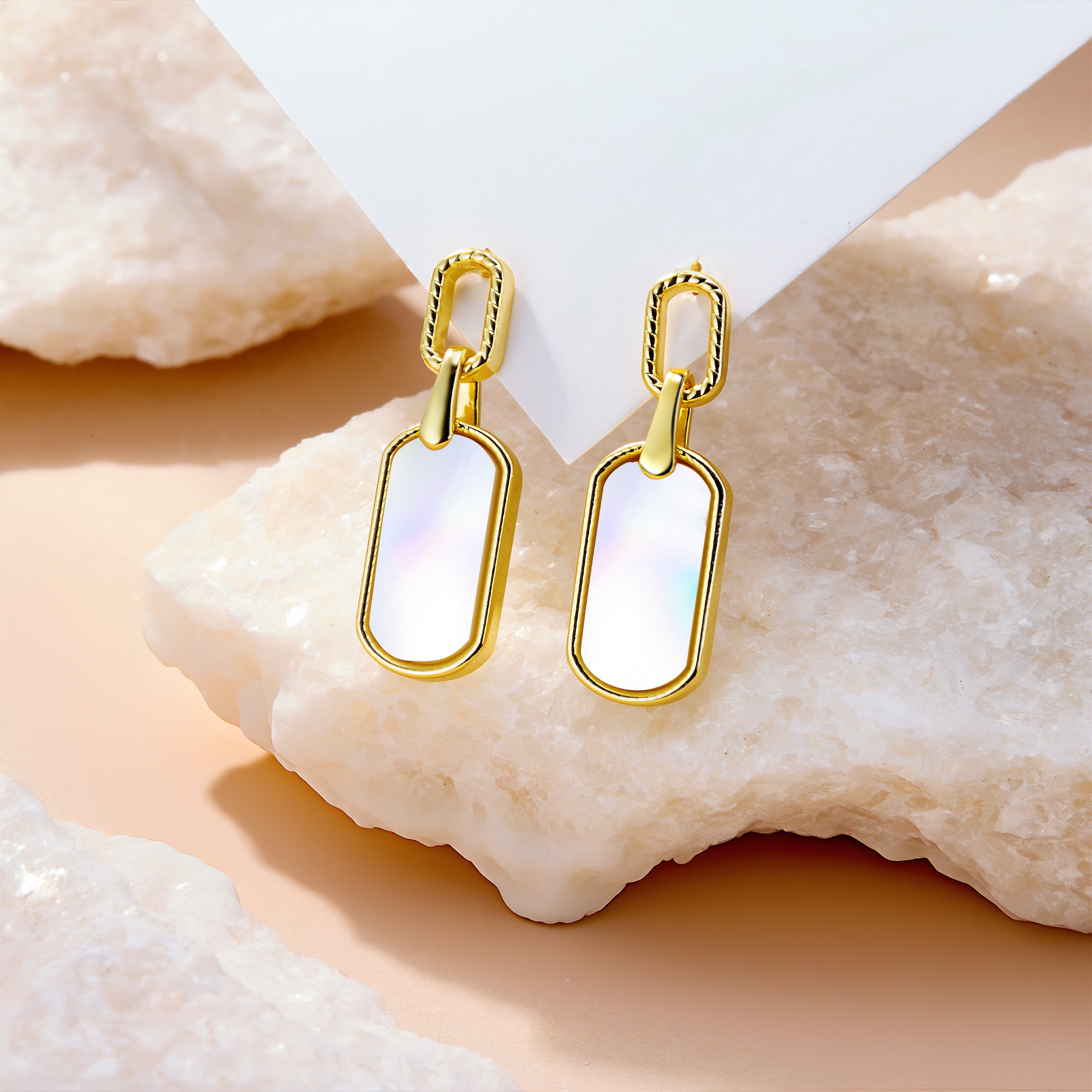 Pearl shell style statement earrings, gold-tone frames with iridescent white rectangular dangles.