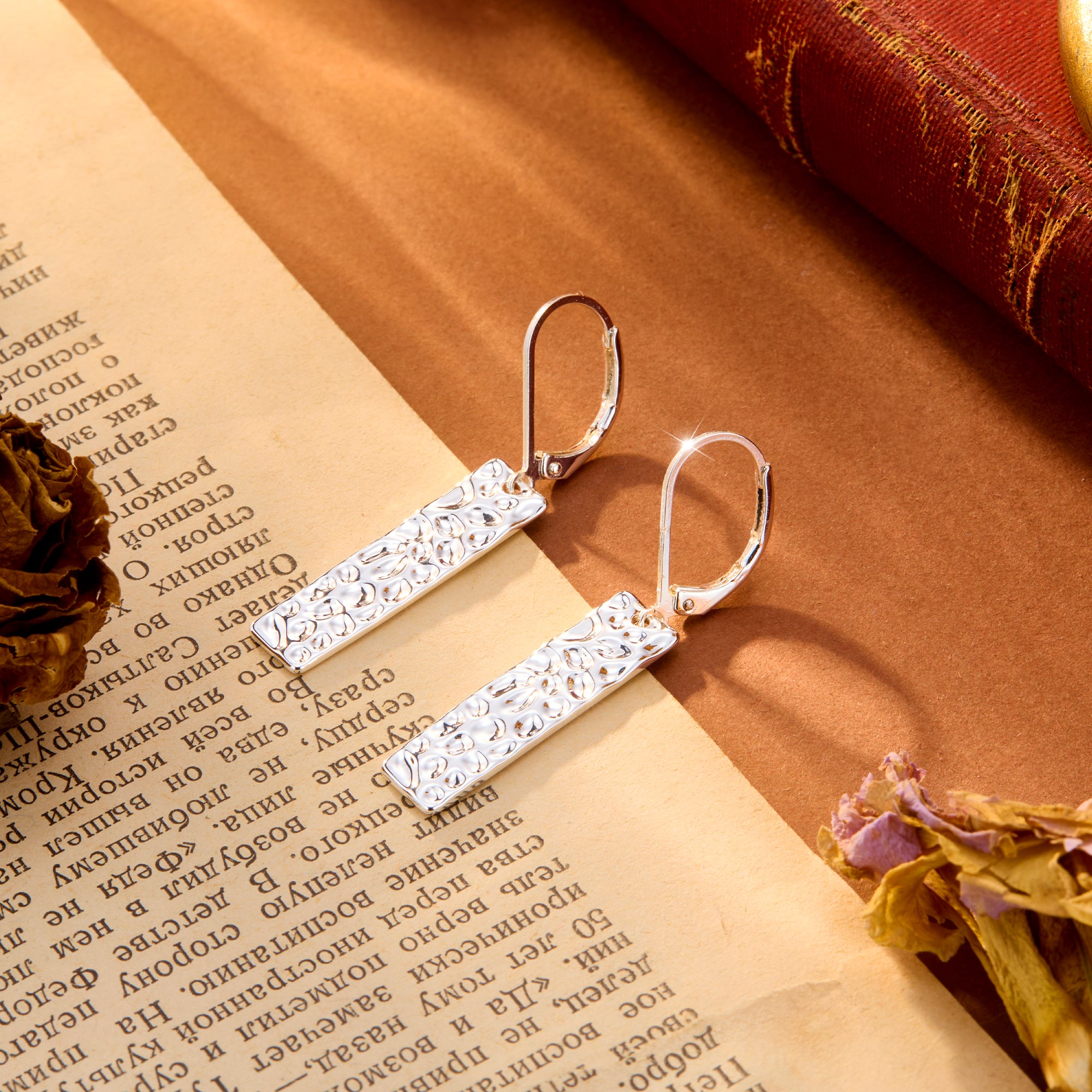 Silver-tone hammered rectangular bar dangle earrings, close-up of textured design