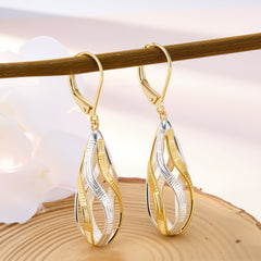 Two-tone twisted teardrop earrings with gold-toned edges and silver ridged interior