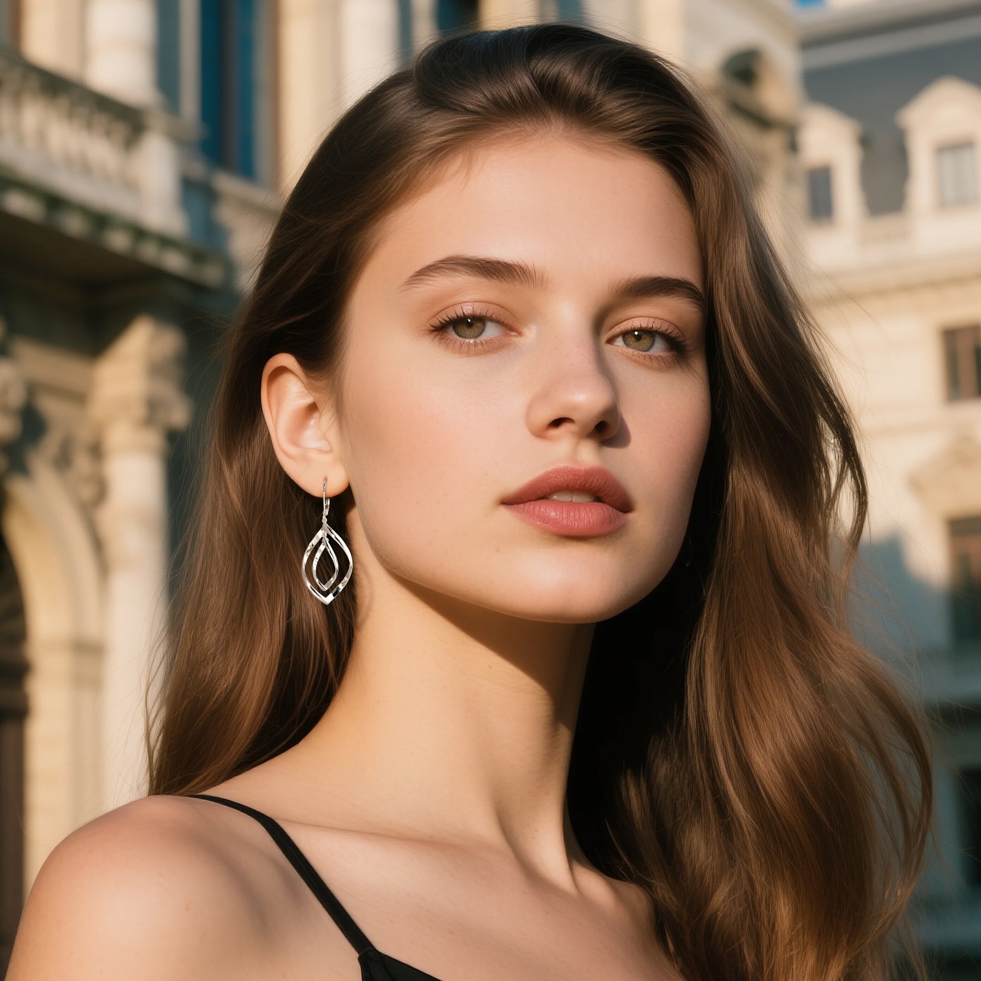 Silver drop earrings with double-twist teardrop loop silhouette