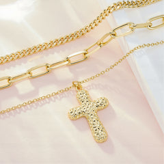 Gold layered heavy-link chains with textured Trinity cross charm