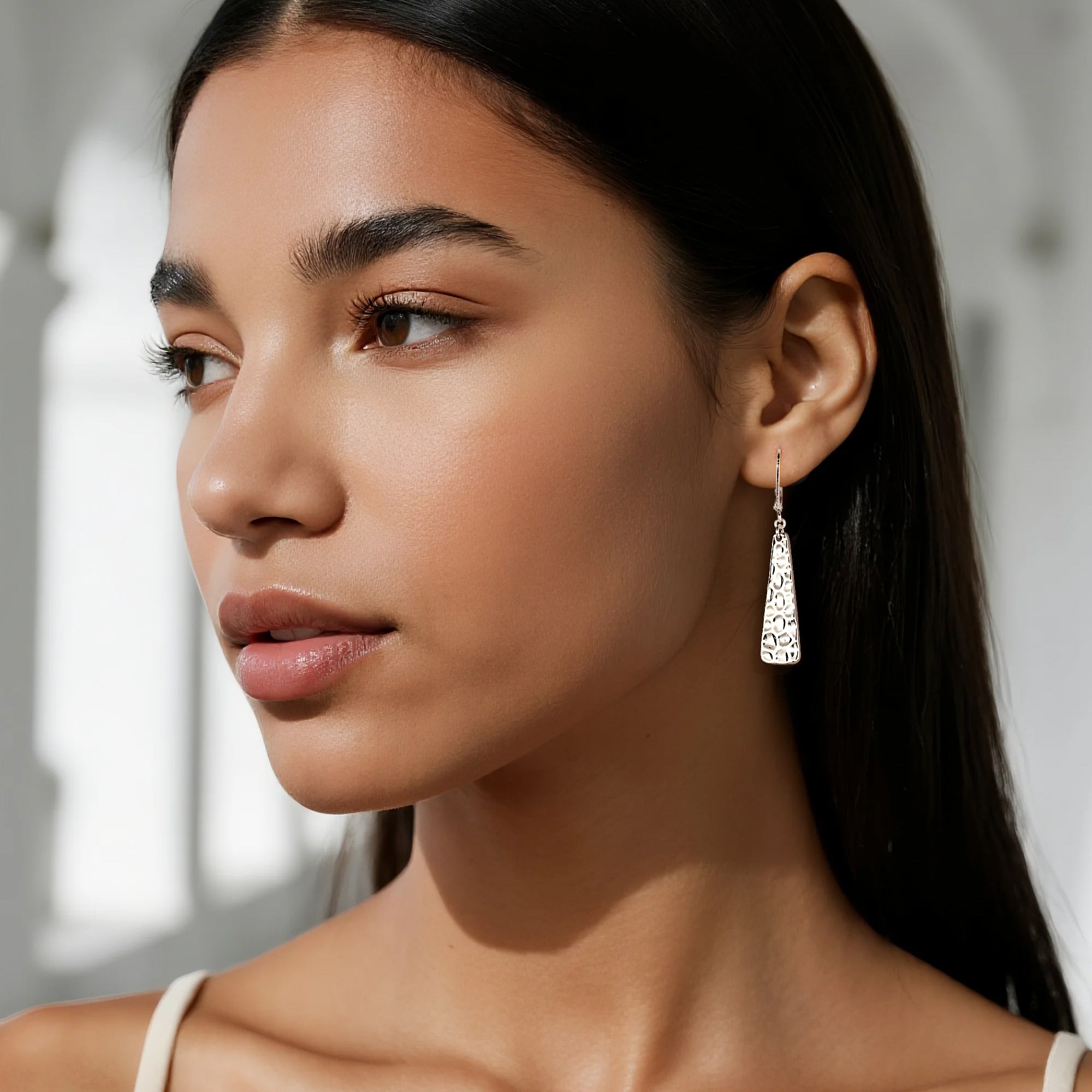 Hammered bar drop earrings, silver tone; model wearing dangling textured bars
