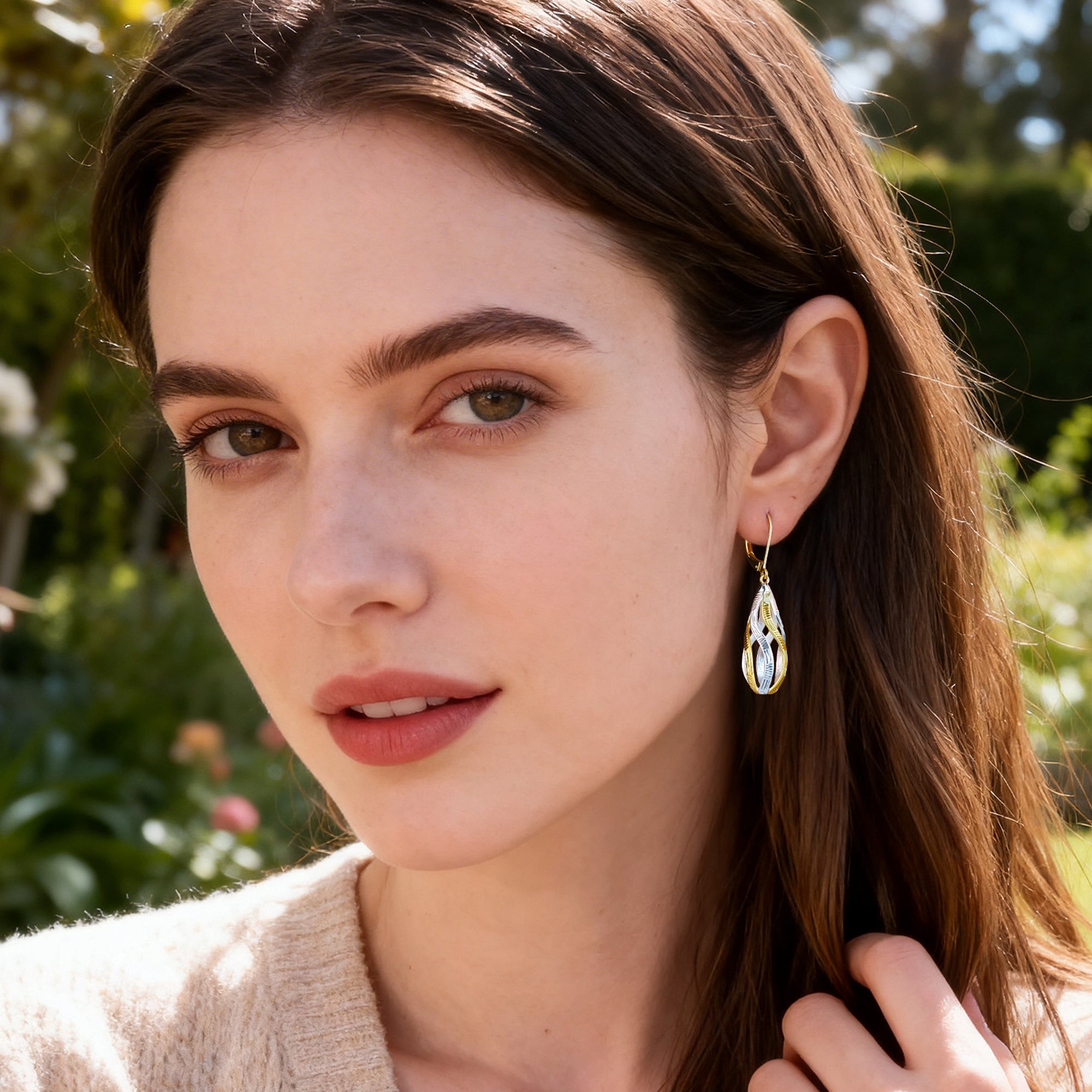 Gold-and-silver twisted teardrop dangle earrings with ridged two-tone finish