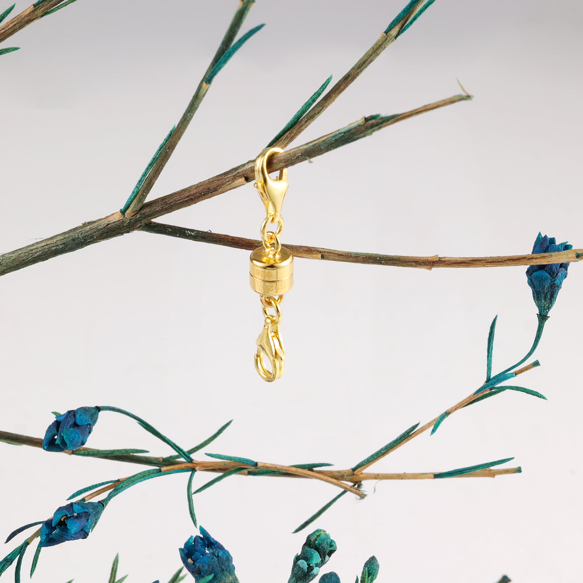 Gold magnetic clasp converter with swivel clasp and chain links, attached to necklace