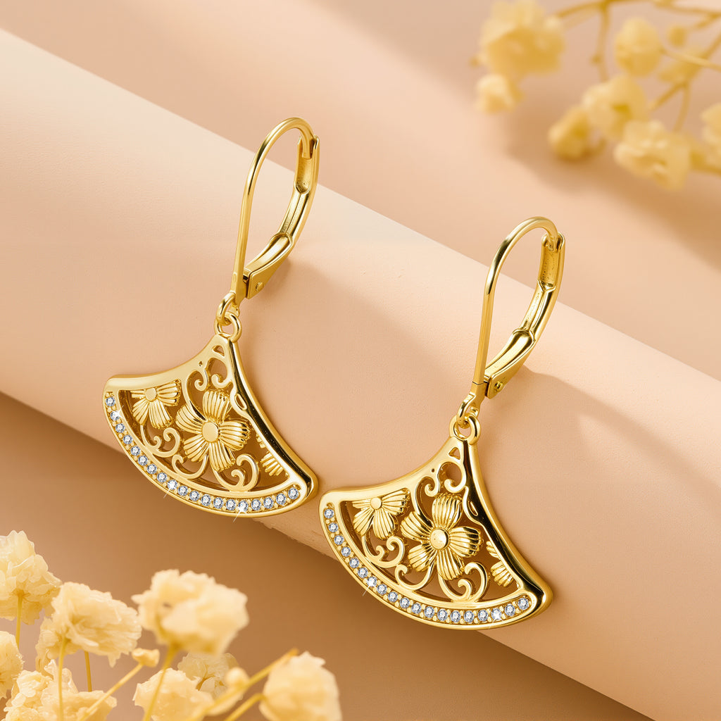 Gold-tone crescent fan drop earrings with rhinestone border and ornate floral cutouts