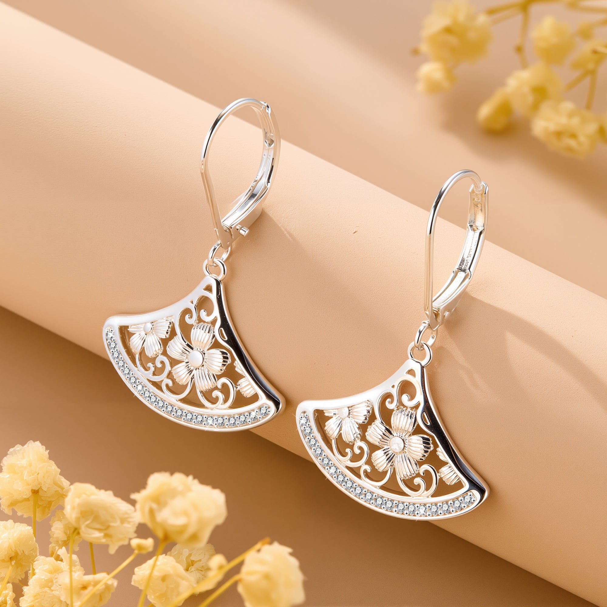 Silver-tone crescent fan drop earrings with floral engraving and rhinestone edge