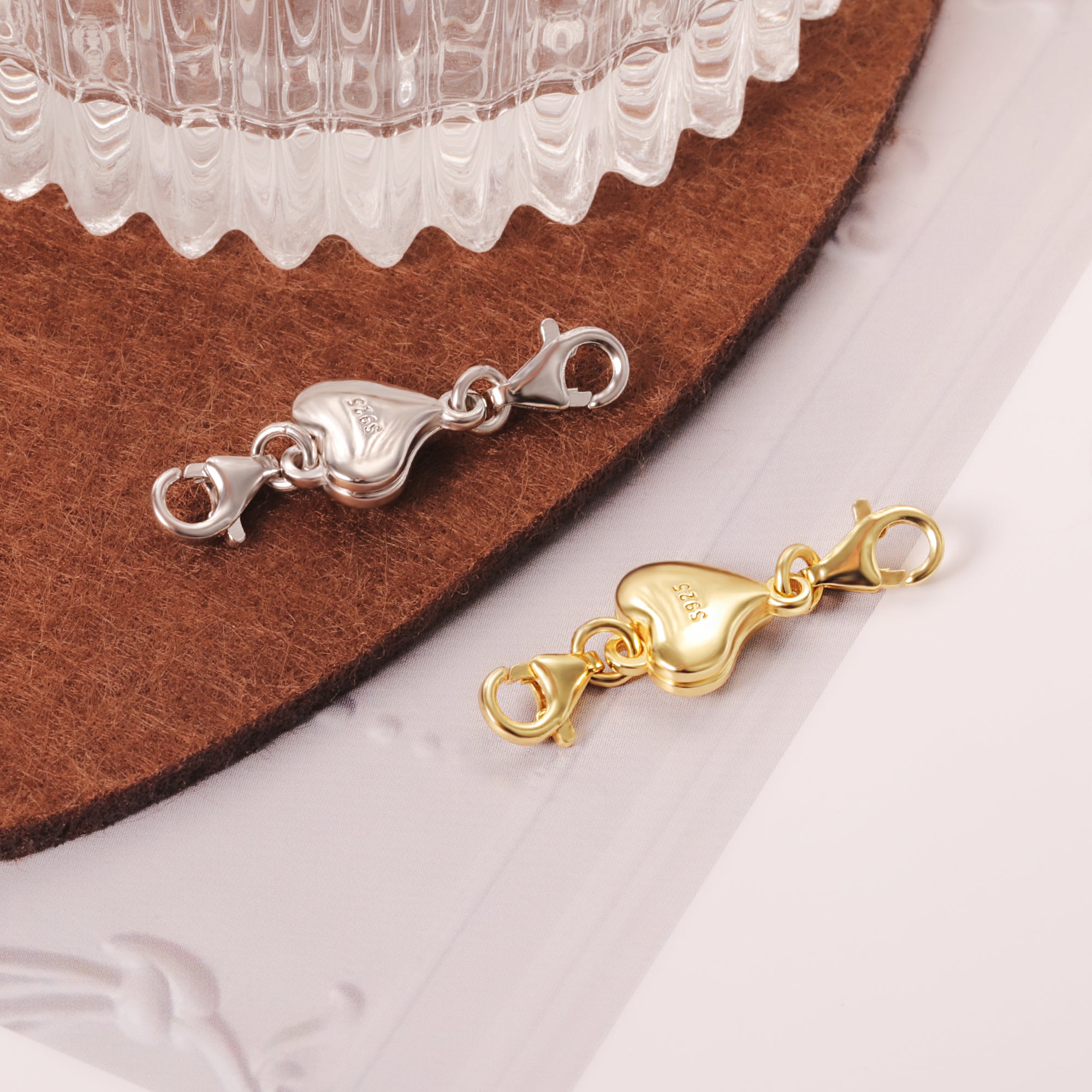 Heart chain extender in silver and gold, both with heart charm and clasp ends