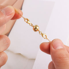Gold-tone linked extender chain with rounded end caps and small clasp anchor