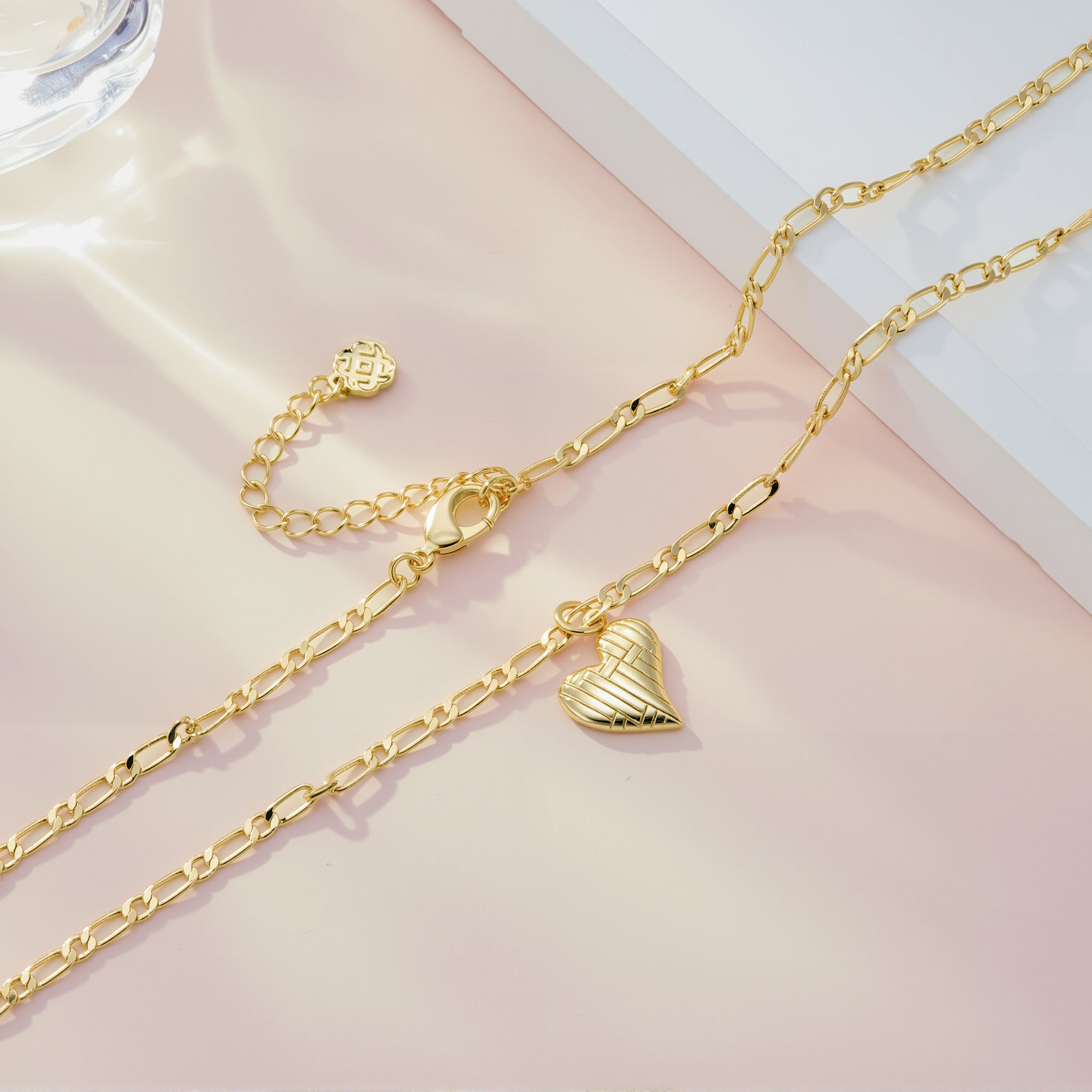 Gold Figaro chain necklace with textured heart pendant charm