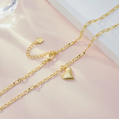 Gold Figaro chain necklace with textured heart pendant charm