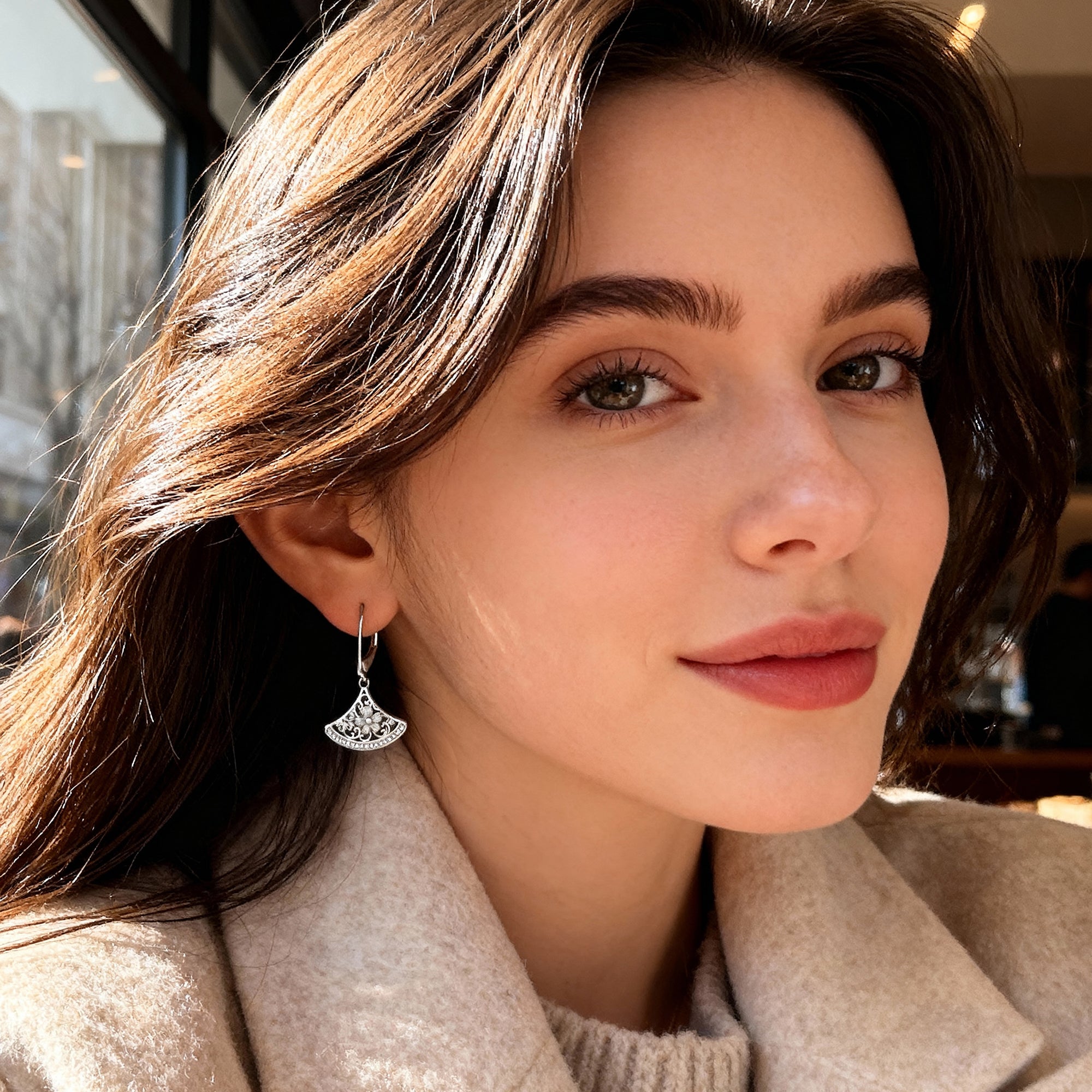 Silver-tone fan drop earrings with crescent filigree and rhinestone detail