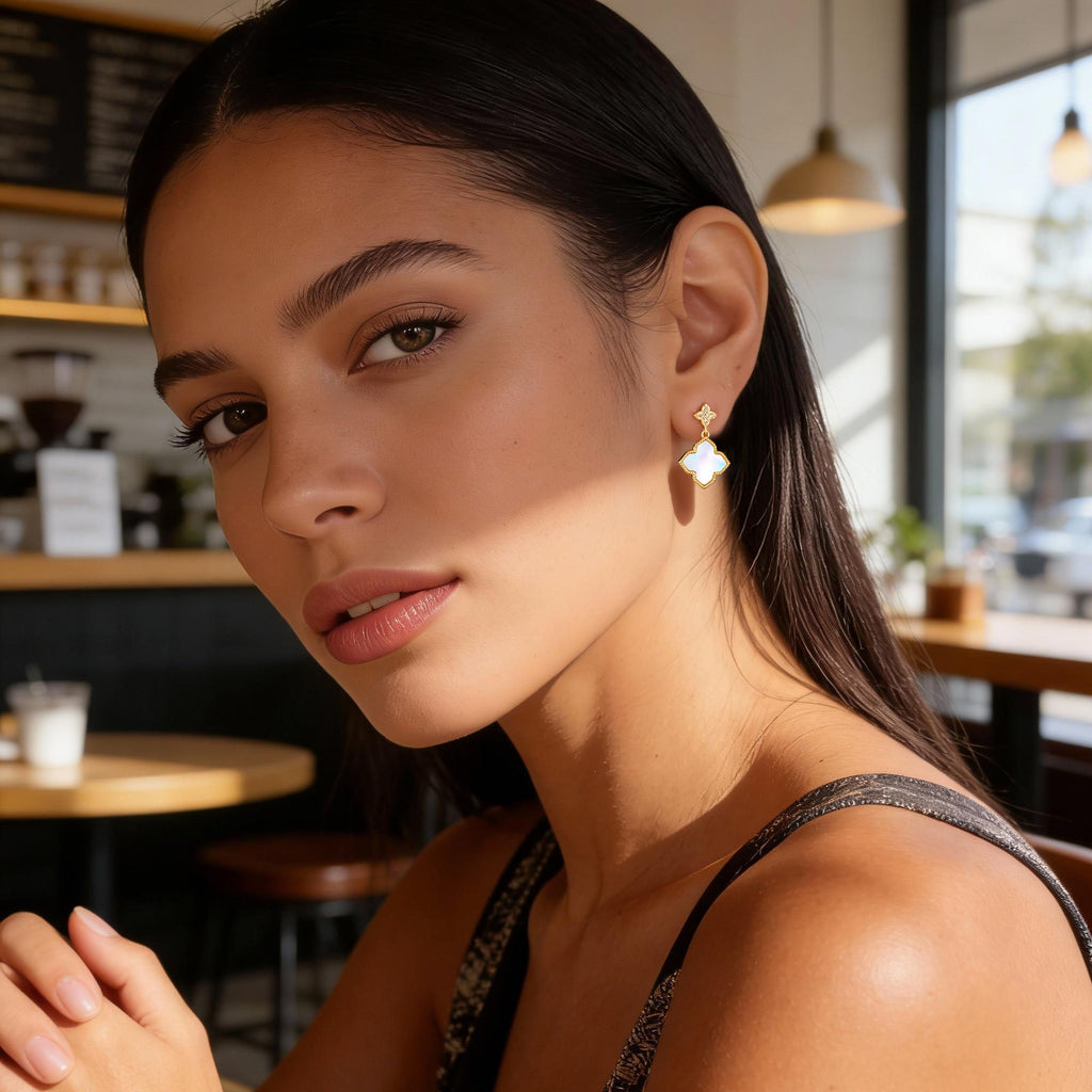 Four-Leaf Clover stud earrings on model: pearl-shell enamel clover with small clear stone accents