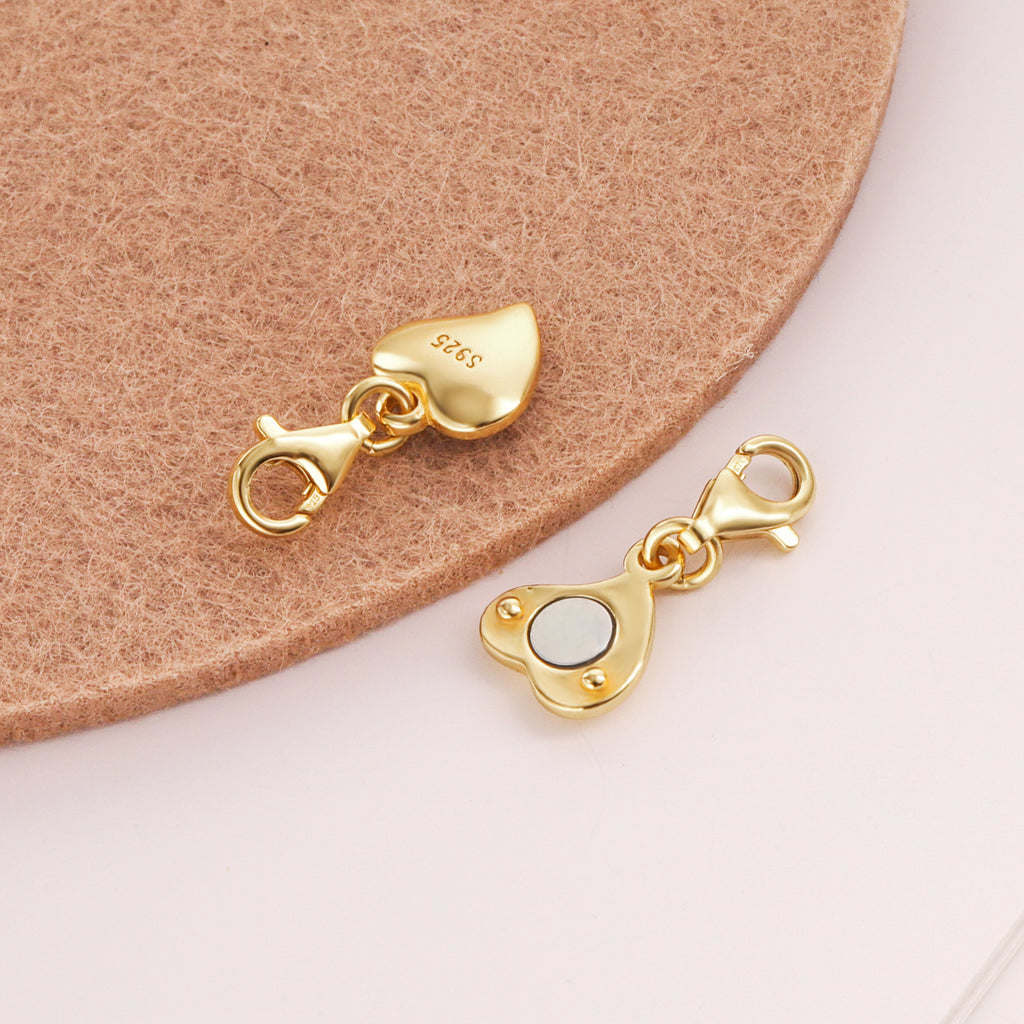 Gold heart chain extender with S925 stamp and round clasp; toggle link detail