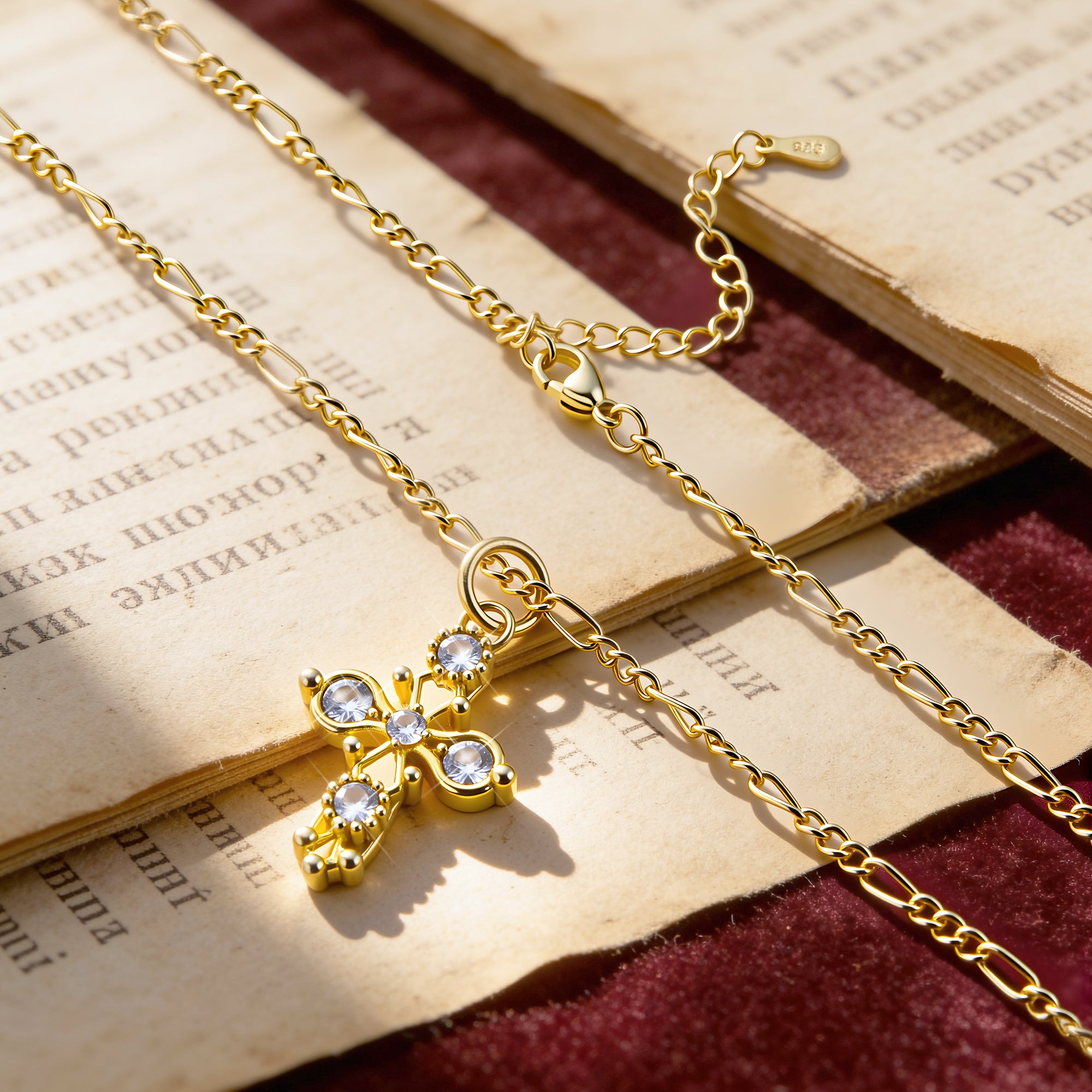 Gold cross pendant necklace with round stone accents and link chain