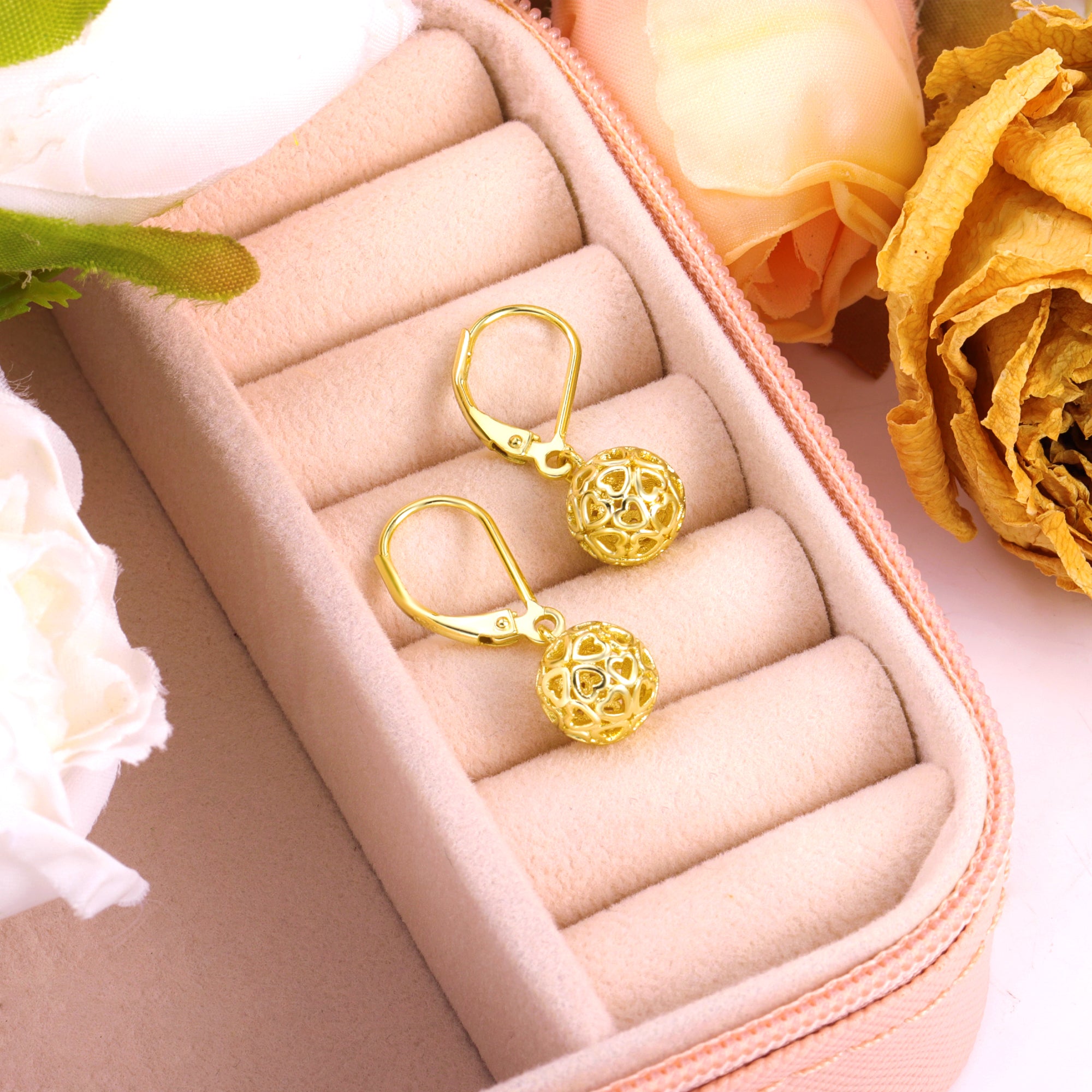 Gold drop earrings with heart-pattern spherical charm and lever hook closure