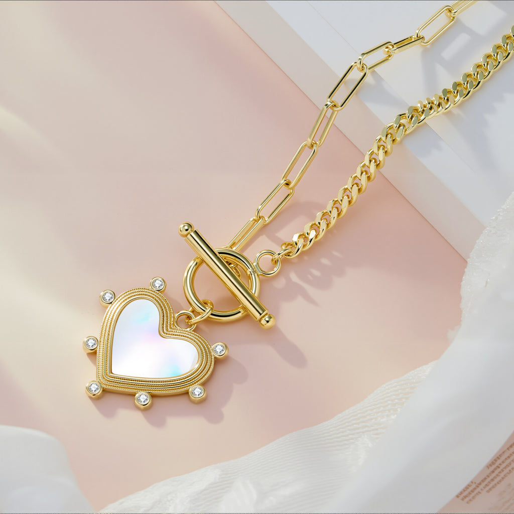 Gold heart pearl charm necklace with blue heart center and stone accents