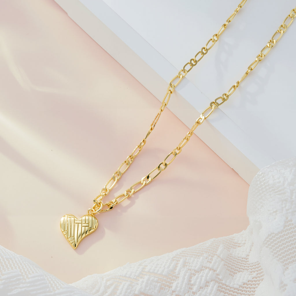 Gold Figaro chain necklace with textured ridged heart pendant
