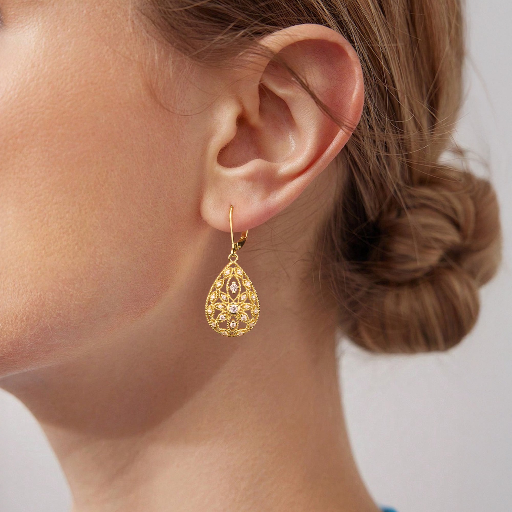 Gold Filigree CZ dangle earring close-up, teardrop filigree with multiple round stones.