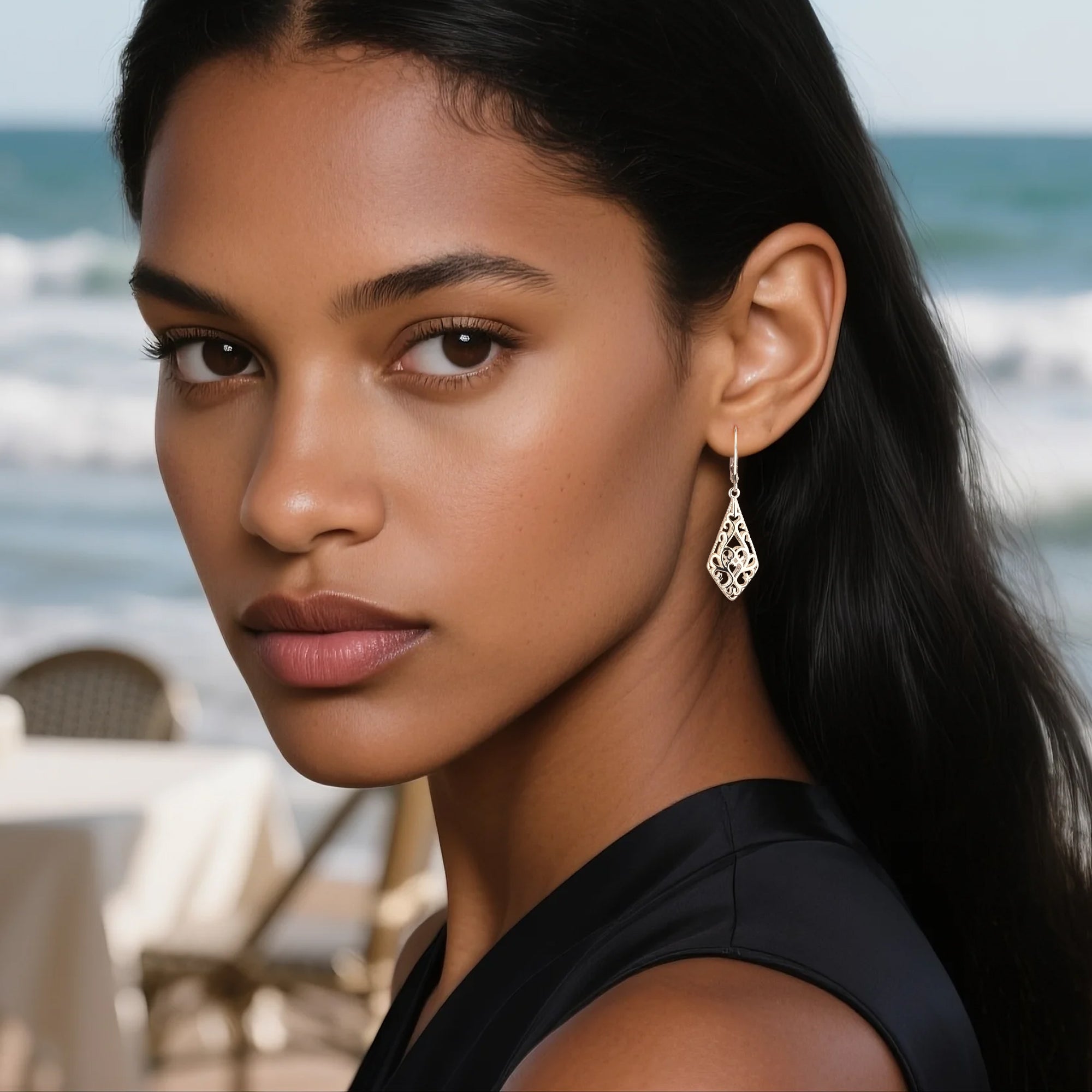 Silver-tone geometric filigree drop earrings on model, teardrop motif