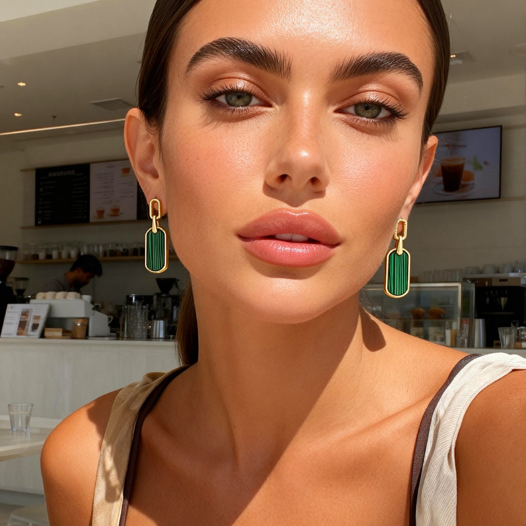 Vintage statement earrings worn: gold hoop with malachite-green rectangular drop.