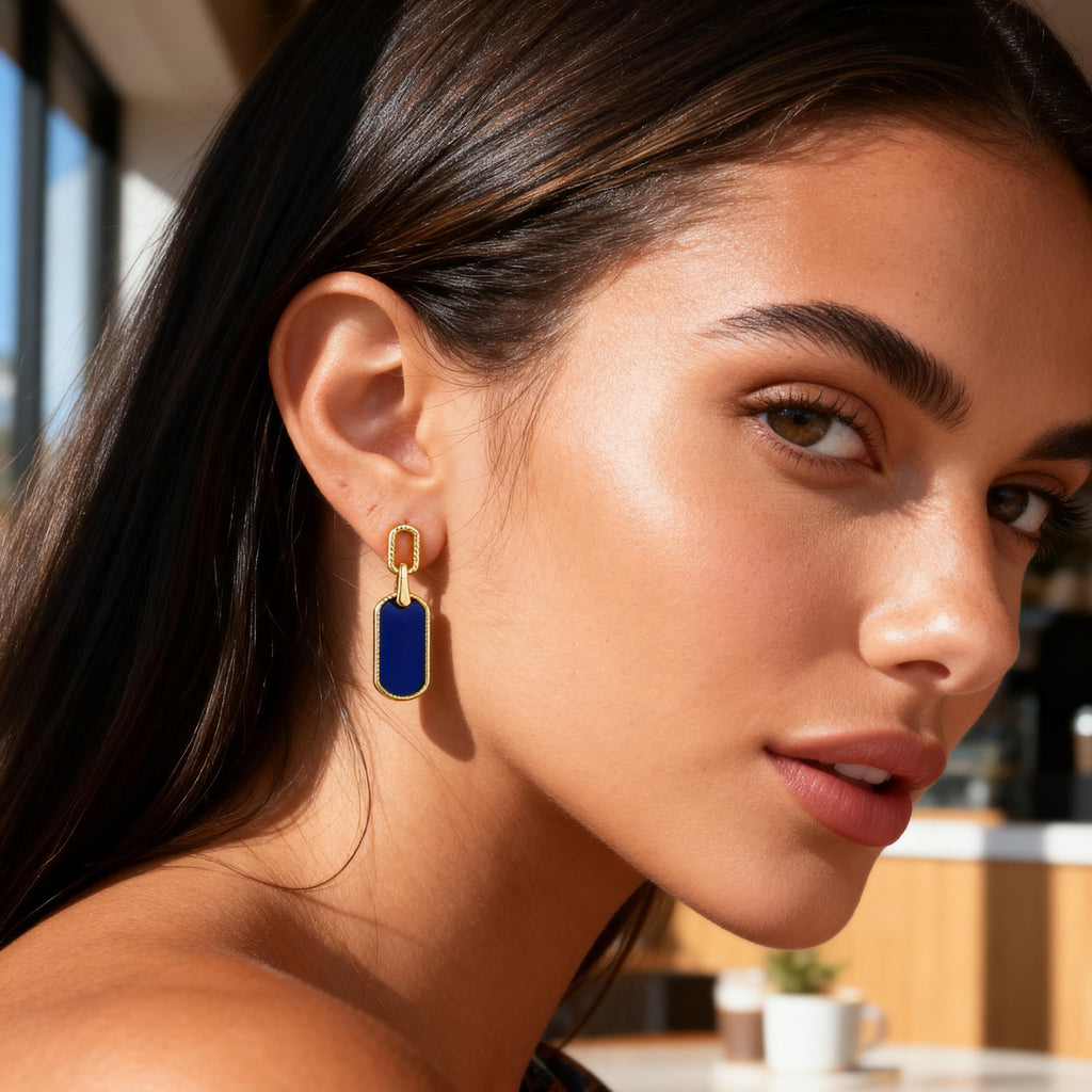 Vintage statement earrings worn: small gold hoop with lapis-blue rectangle drop.