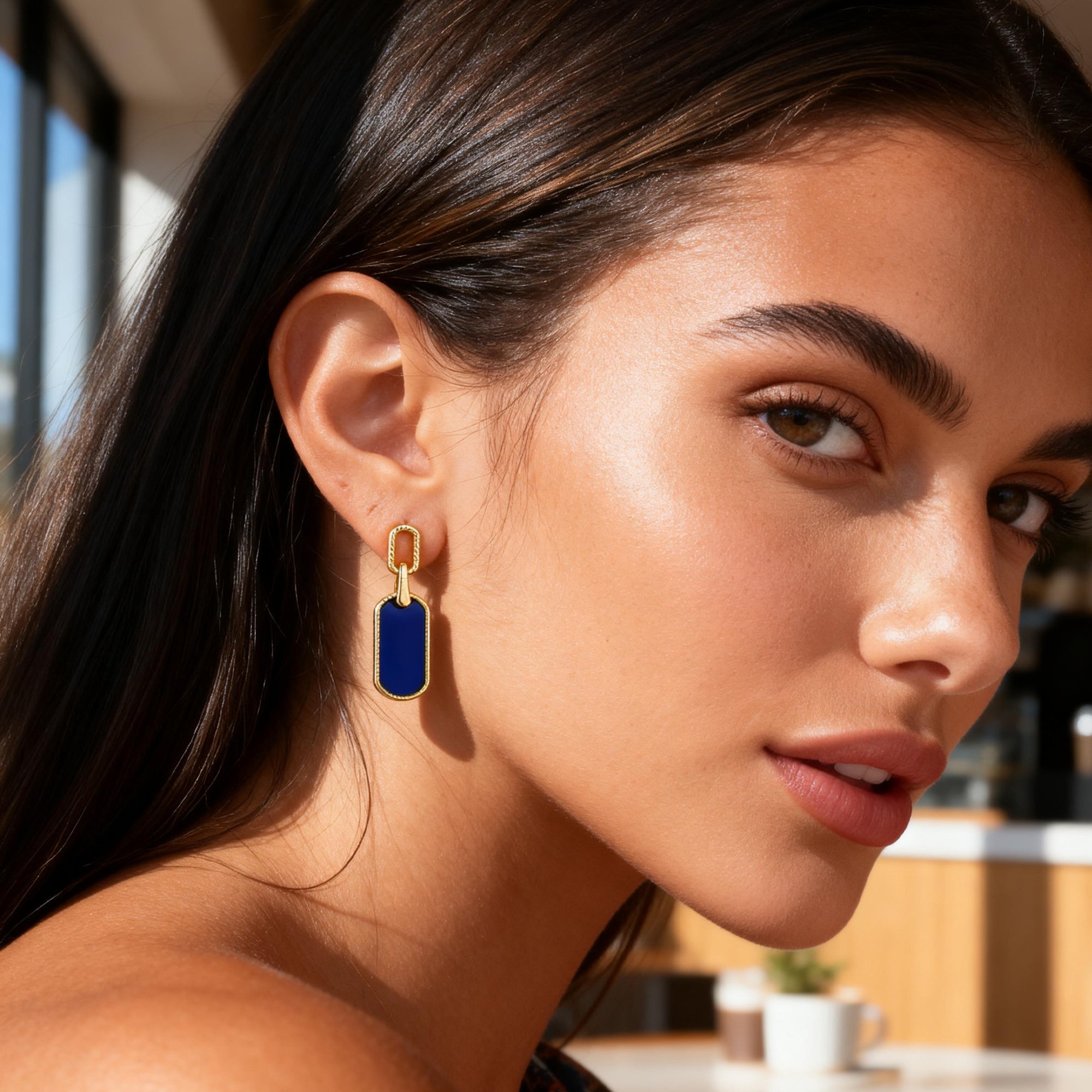 Vintage statement earrings worn: small gold hoop with lapis-blue rectangle drop.