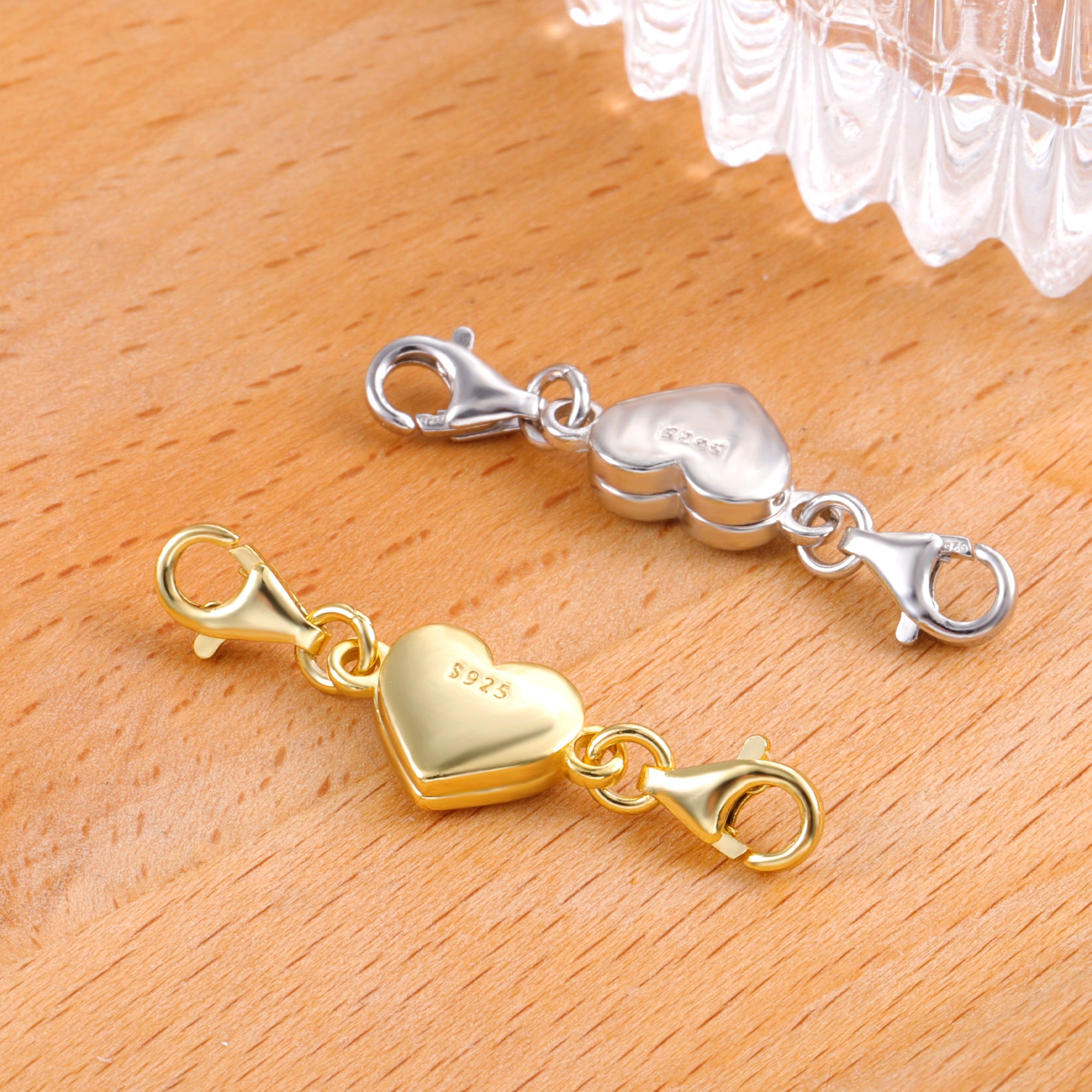 Pair of heart magnetic clasps in gold and silver with lobster-style hook ends