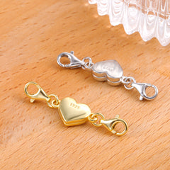 Pair of heart magnetic clasps in gold and silver with lobster-style hook ends