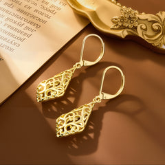 Gold-tone geometric filigree drop earrings with ornate teardrop detailing