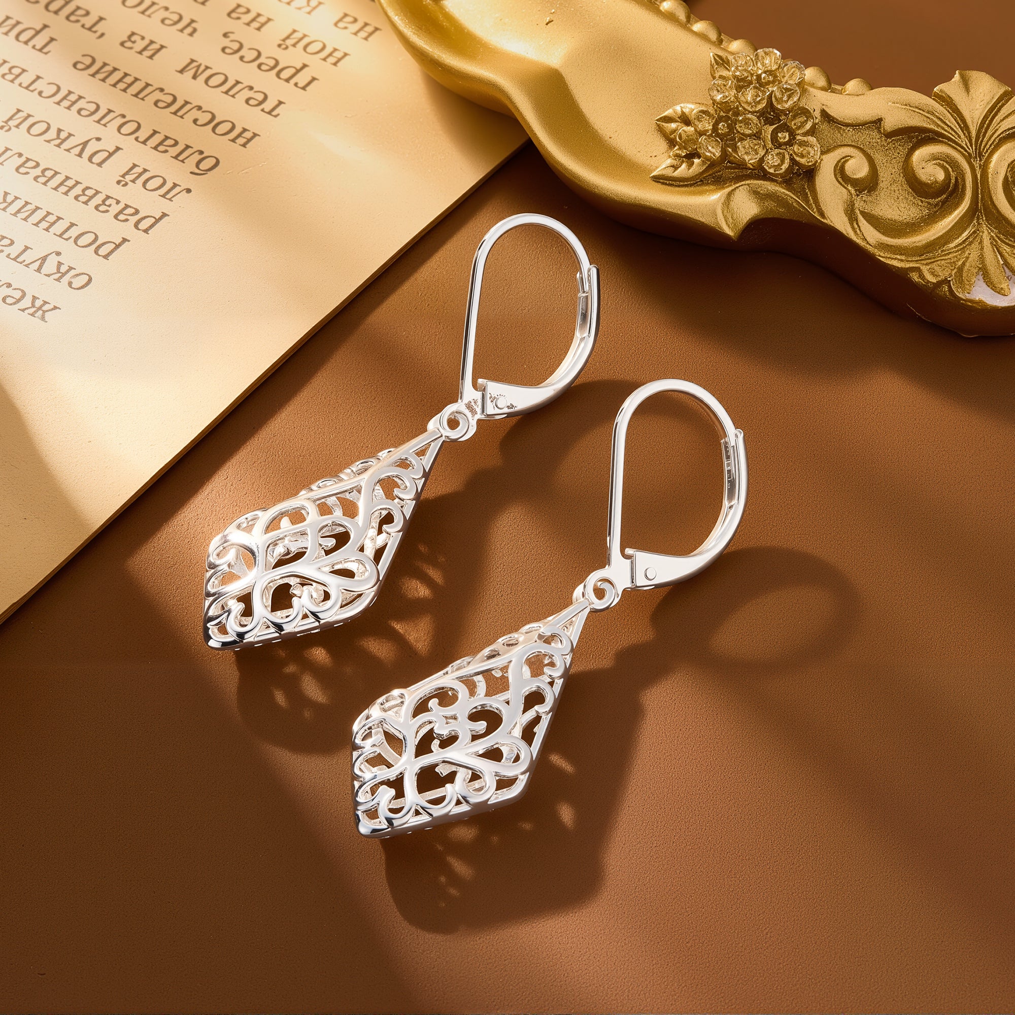Silver-tone geometric filigree drop earrings with ornate teardrop detailing