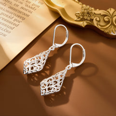 Silver-tone geometric filigree drop earrings with ornate teardrop detailing