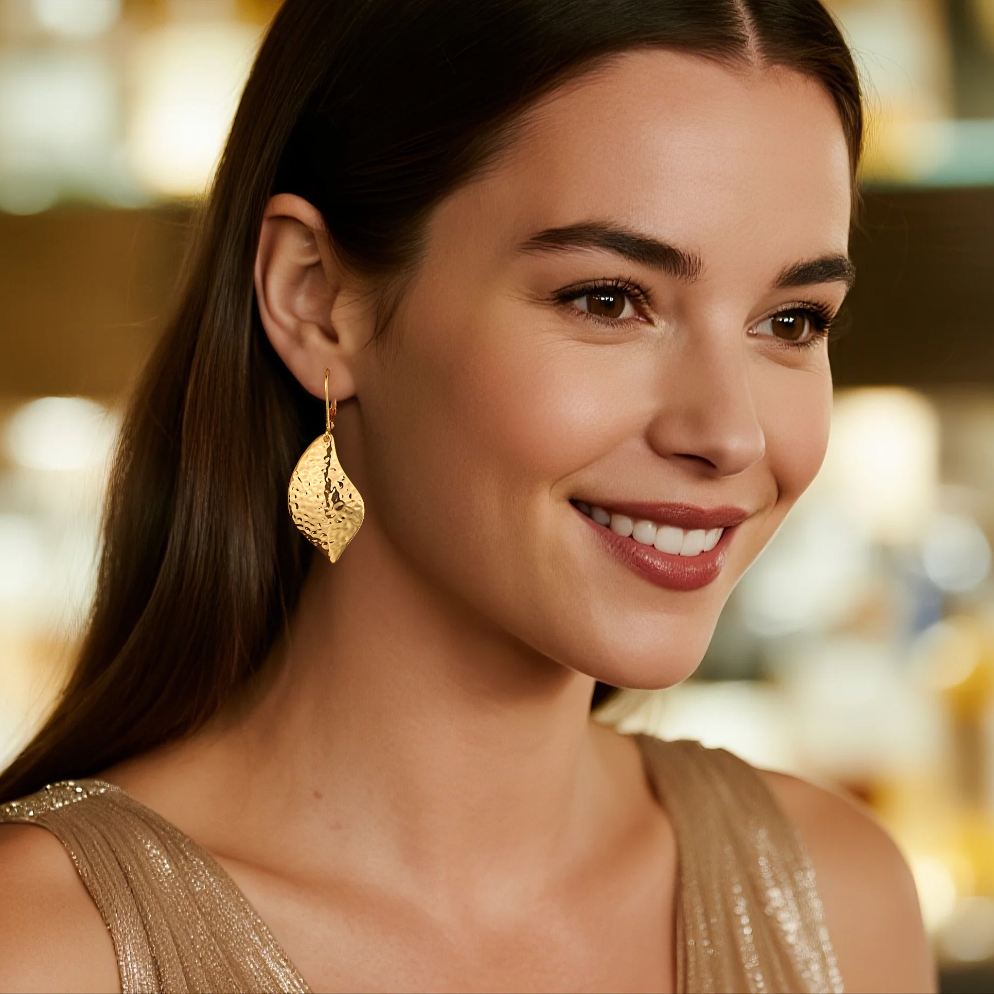 Gold-tone hammered leaf drop earrings with textured teardrop dangle and lever back