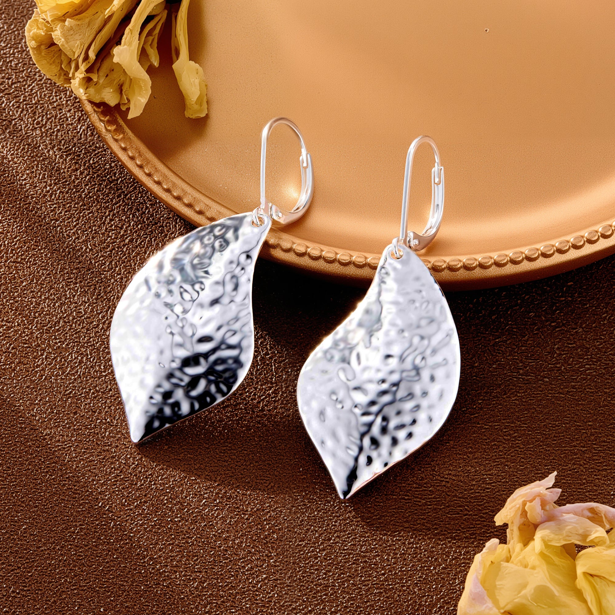 Silver hammered leaf drop earrings with teardrop leaf shape and textured face