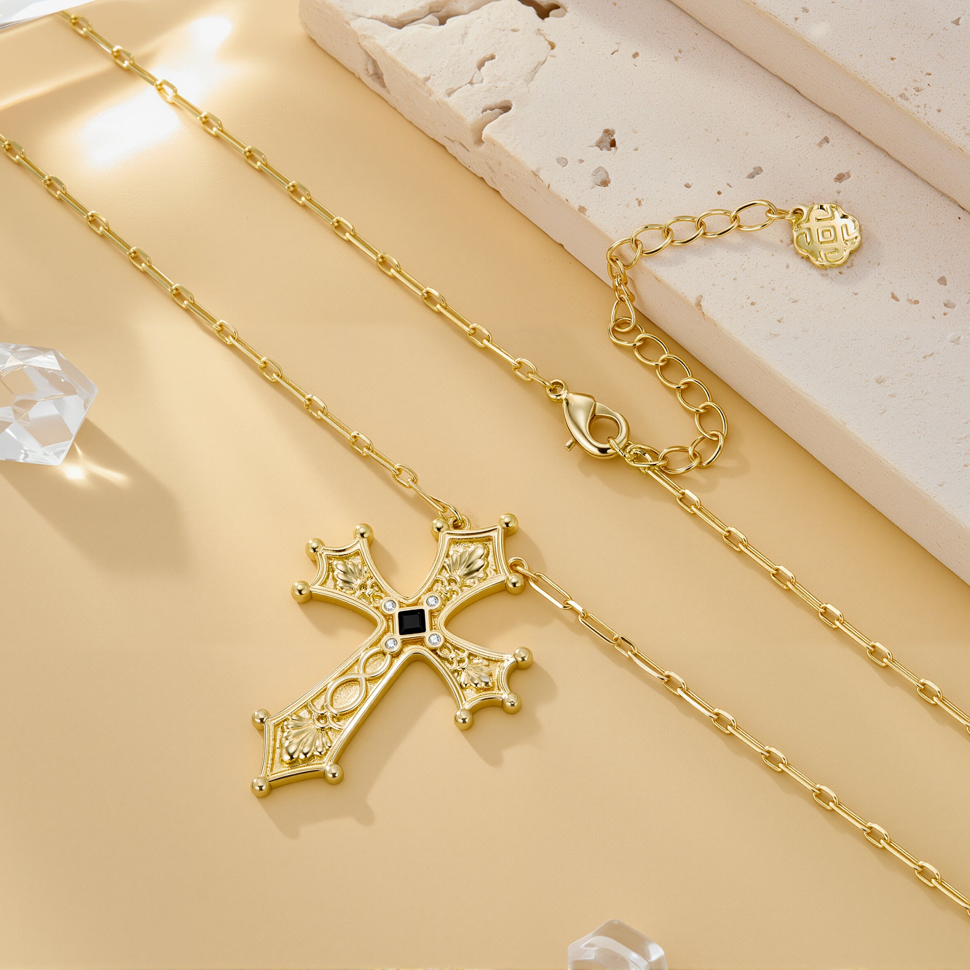 Gold baroque cross pendant necklace with link chain and small round clasp detail