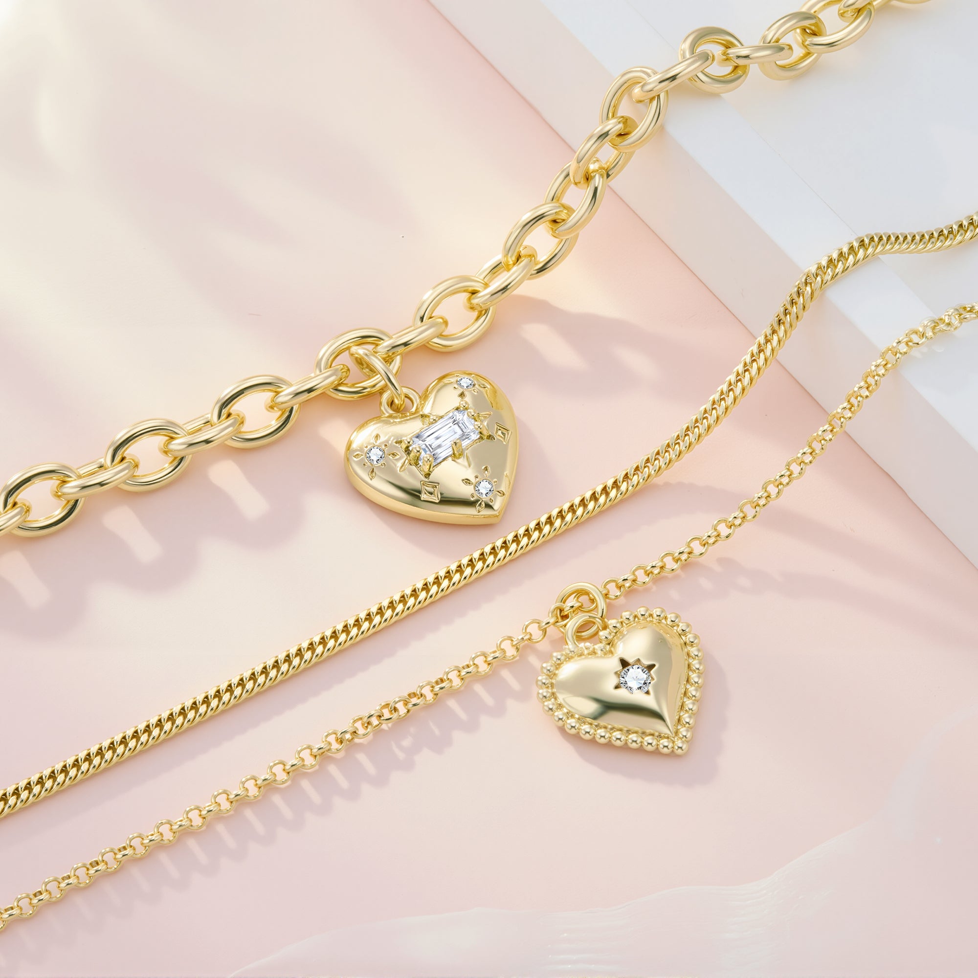Gold interlinked chain layers with heart pendant featuring star-shaped center stone