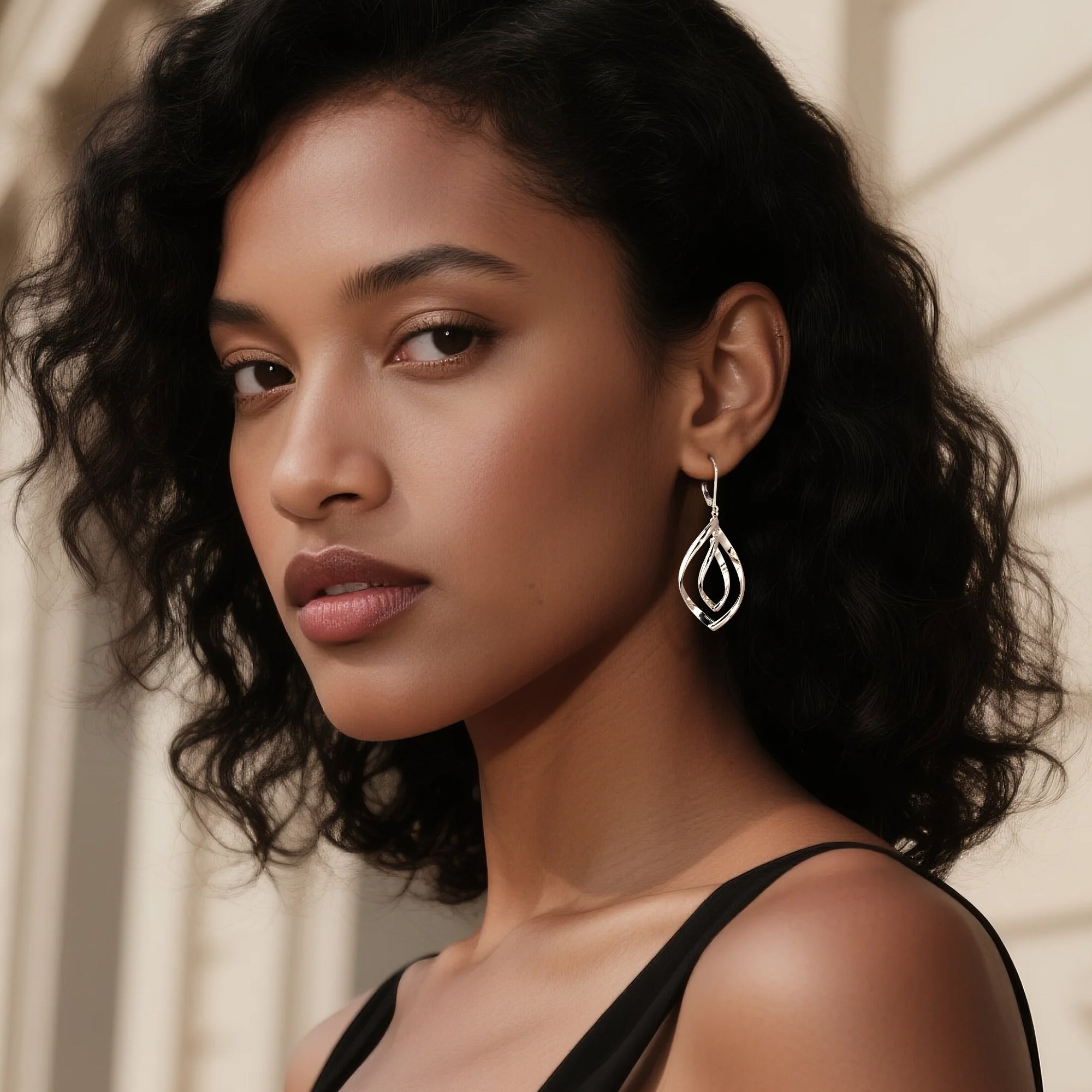Silver teardrop double-twist drop earrings with nested loop detailing