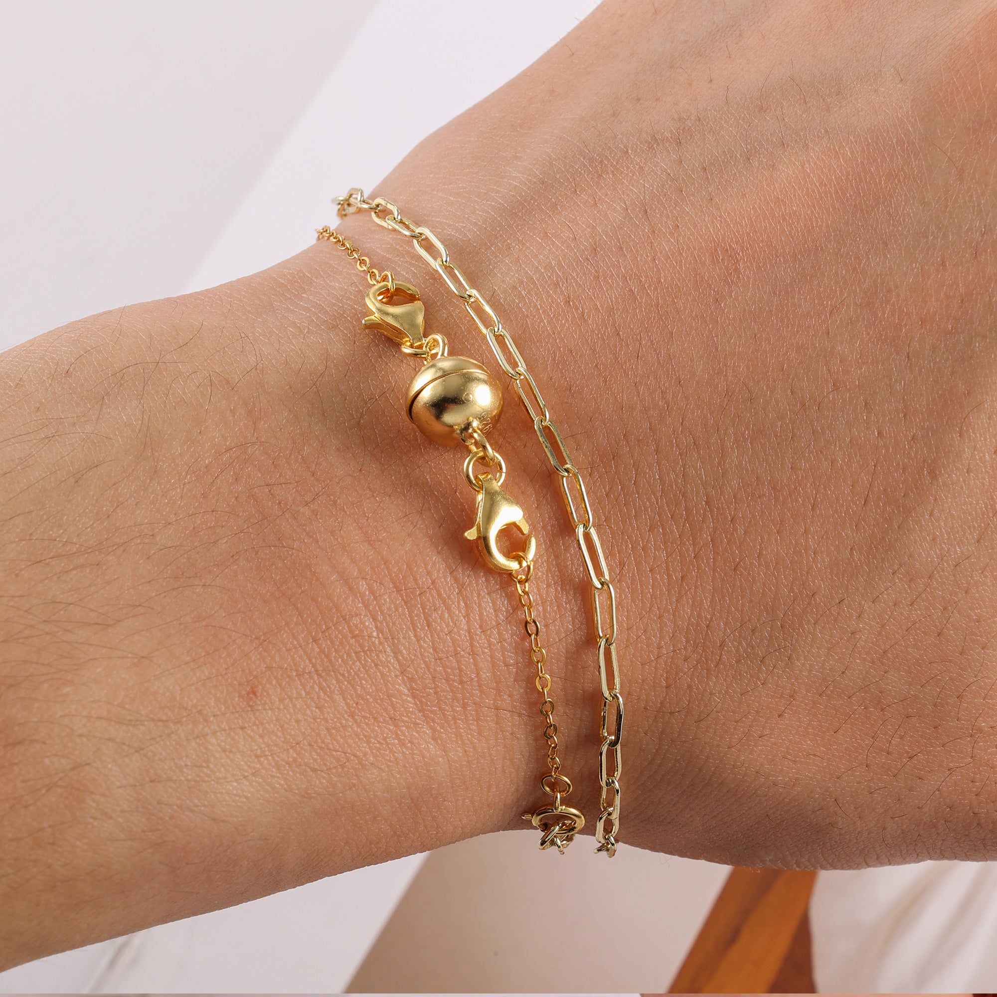 Gold-tone wrist extender set with two chain bracelets and round ball connector