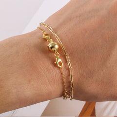 Gold-tone wrist extender set with two chain bracelets and round ball connector