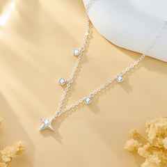 Silver-tone chain necklace with star pendant and round zircon stations along the length