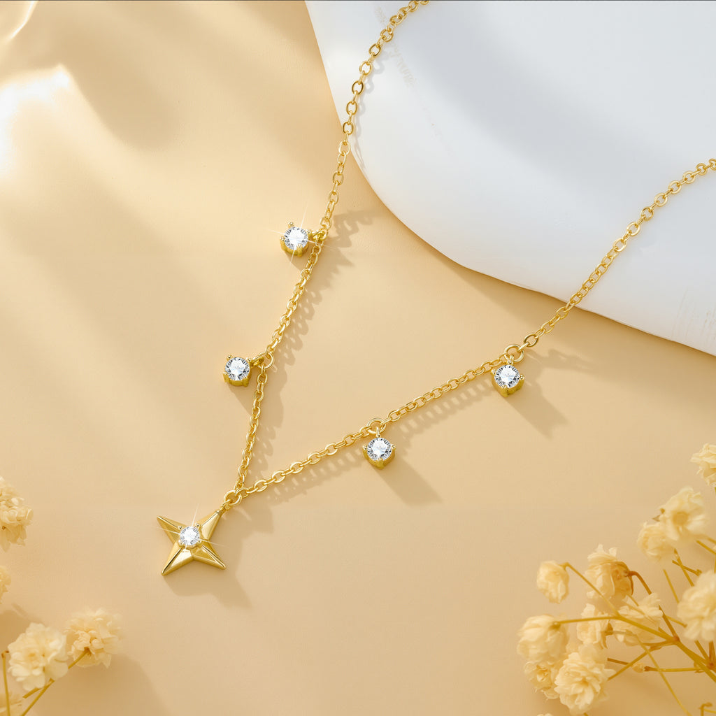 Gold-tone chain necklace with star pendant and round zircon charms along the links