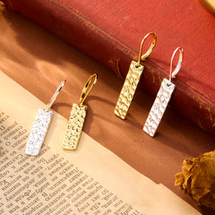Hammered bar drop earrings in gold and silver tones, with rectangular textured dangles