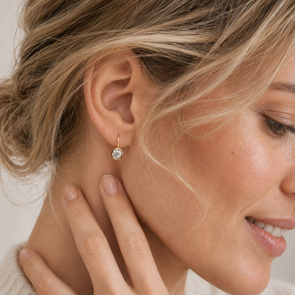 Woman wearing gold plated moissanite leverback earrings
