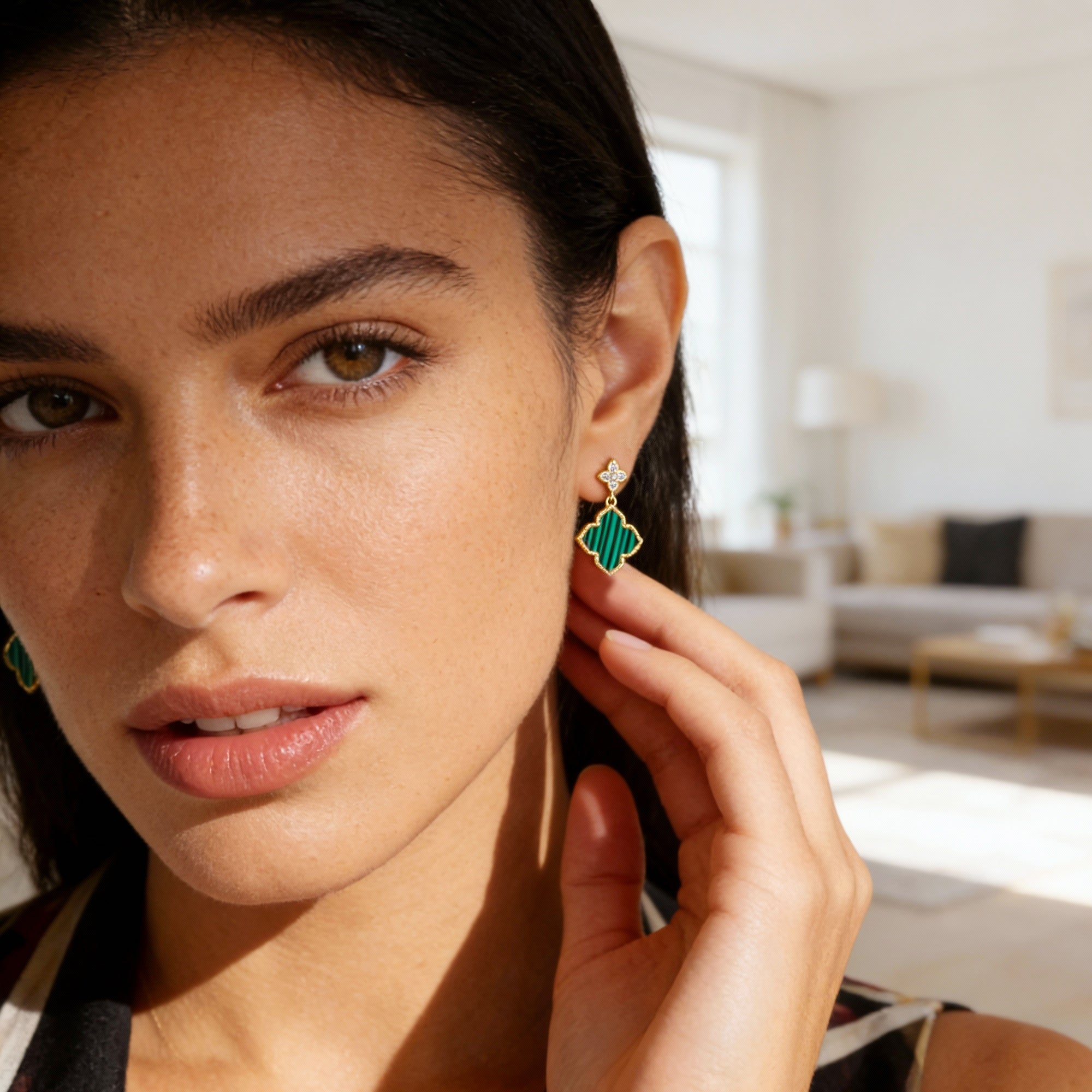 Four-Leaf Clover stud earrings on model: green malachite enamel clover with gold-tone details