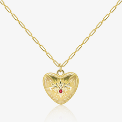 Gold paperclip chain necklace with embossed heart pendant and red gemstone center