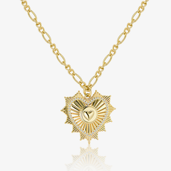 Gold Figaro chain necklace with radiant heart pendant and pavé sparkle detail